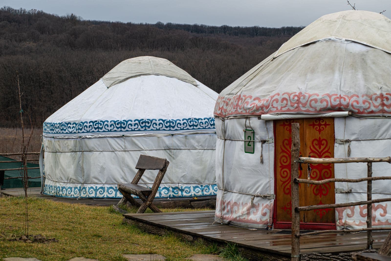 Two canvas yurts pitched in a serene rural setting