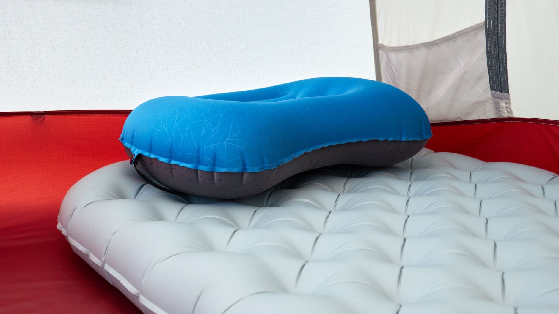 An inflatable pillow on a sleeping mat inside a tent