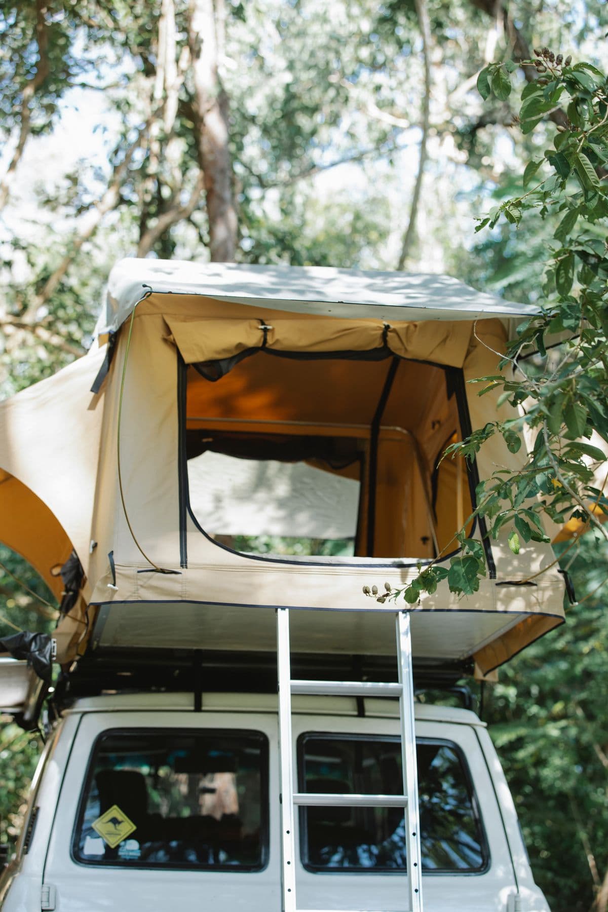 A rooftop tent set up on a vehicle for car camping